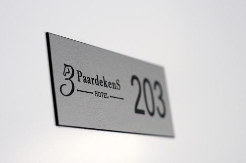 a television screen with the number two on it at 3 Paardekens - City Centre Hotel in Mechelen