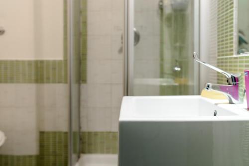 a bathroom with a sink and a shower at Hostel of the Sun in Naples