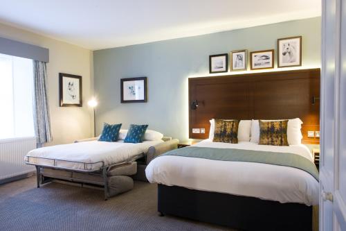 a hotel room with two beds and a window at Balloch House by Innkeeper's Collection in Balloch