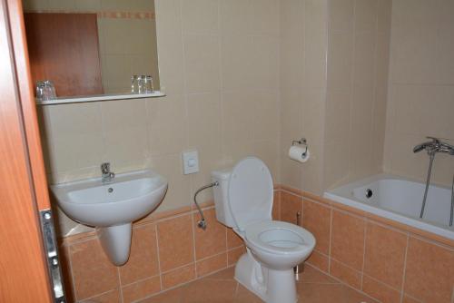 a bathroom with a toilet and a sink and a tub at Penzion na Potočnej in Skalica