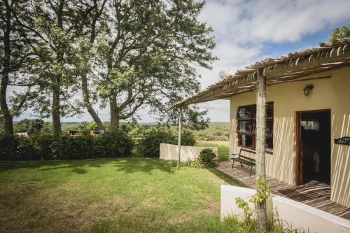 a house with a yard with a porch at Oribi Gorge Guest Farm in Glendale