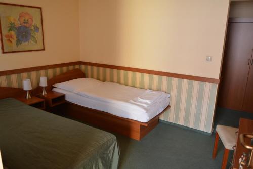 Posteľ alebo postele v izbe v ubytovaní Penzion na Potočnej