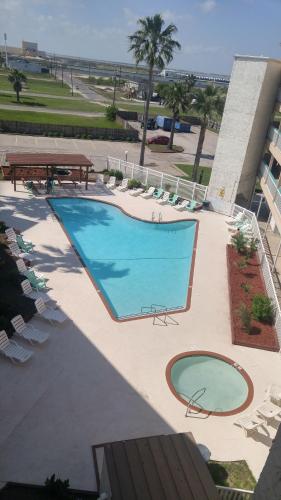 an overhead view of a swimming pool with chairs and tables at 'It's All Good!' in Corpus Christi
