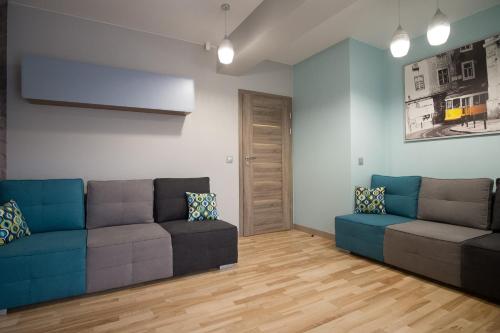 a living room with two couches and a wooden floor at VIP Apartamenty Stara Polana 2 in Zakopane