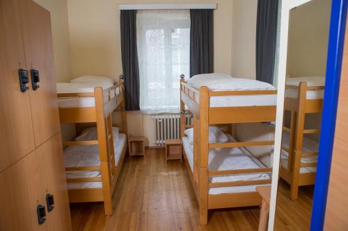 a room with two bunk beds and a window at YoHo - International Youth Hostel in Salzburg