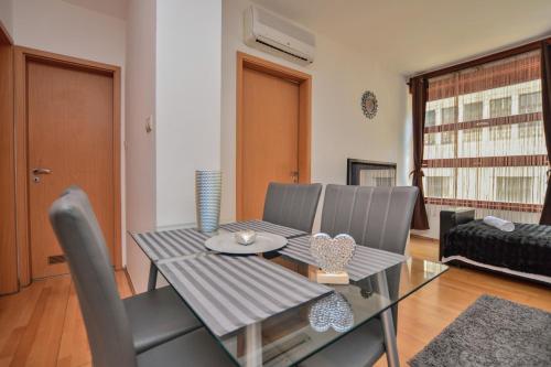 a dining room with a glass table and chairs at DeSiGn free parking apartment in city center in Budapest