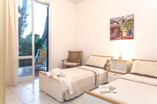 a hotel room with two beds and a balcony at la casa nell'acqua in Otranto