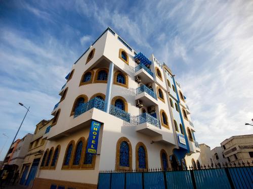 a white building with blue balconies on it at Hôtel El Kasbah Souiria in Essaouira