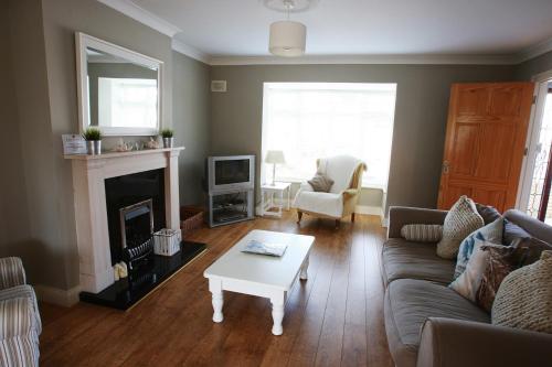 a living room with a couch and a coffee table at Glen Ard Holiday Home No 1 by Trident Holiday Homes in Dunmore East