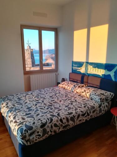 a bedroom with a bed and a window at Sant’Antonio in Finale Ligure