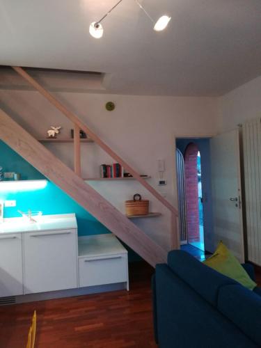 a living room with a staircase and a couch at Sant’Antonio in Finale Ligure