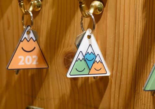 a pair of keychains hanging on a wooden door at Family Apart Stubai in Fulpmes