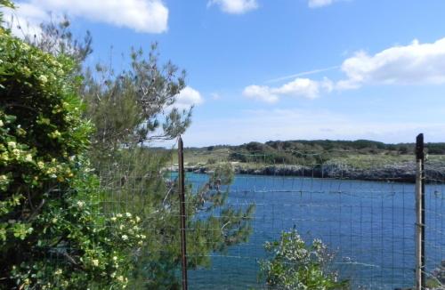 a view of a river from a fence at la casa nell'acqua in Otranto