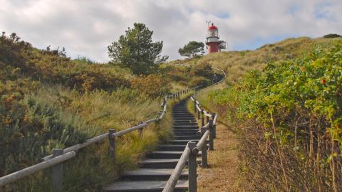 a staircase leading up to a lighthouse on a hill at WestCord Hotel de Wadden in Oost-Vlieland