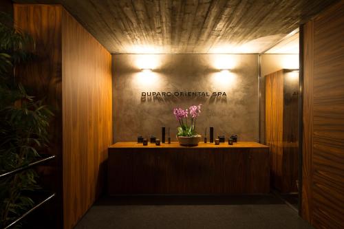 a bathroom with a counter with flowers in it at DUPARC Contemporary Suites in Turin