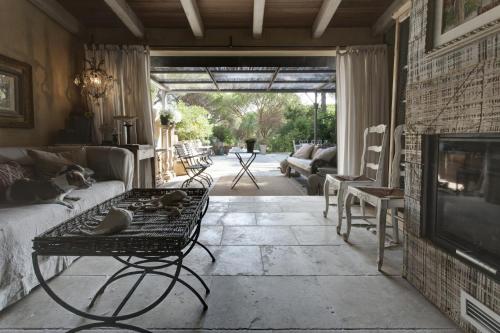 a living room with a dog sitting on a couch at Maison de charme Pampelonne Saint Tropez in Saint-Tropez