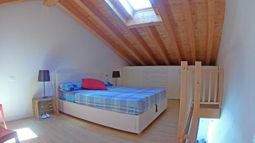 a bedroom with a bed in a attic at La Quiete 58 Maisonette Lake view by Gardadomusmea in Pieve