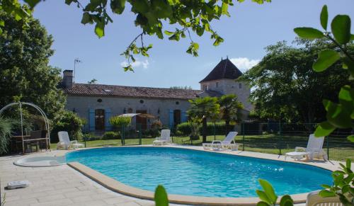 a swimming pool in front of a building at Chez Moutier in Monestier
