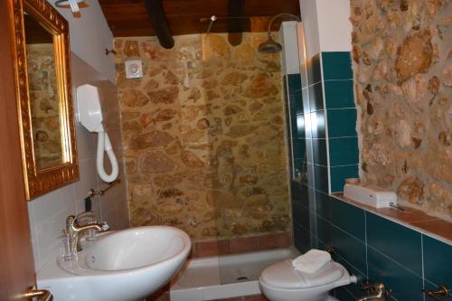 a bathroom with a sink and a toilet and a shower at Grand Hotel La Batia in Alcamo