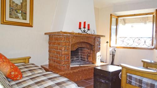 a living room with a brick fireplace at Casa del Borgo Olga by Gardadomusmea in Tremosine Sul Garda