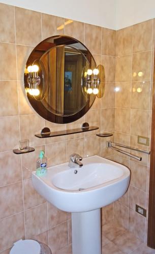 a bathroom with a sink and a mirror at Casa del Borgo Olga by Gardadomusmea in Tremosine Sul Garda