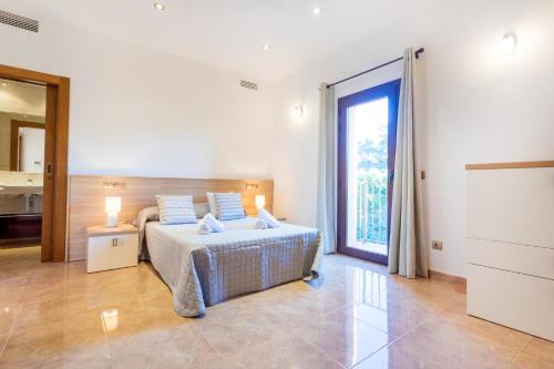 a bedroom with a bed and a large window at Villa Alexandra in Talamanca