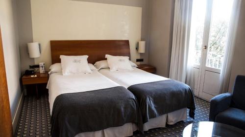 a hotel room with a bed and a window at Gran Hotel Albacete in Albacete