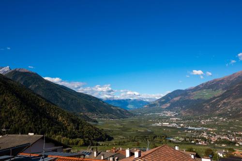 a view of a town in a valley with mountains at Pension Sachsalber in Laces