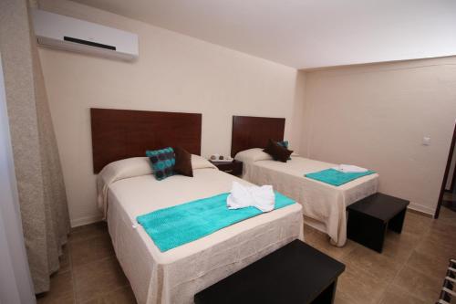 Ein Bett oder Betten in einem Zimmer der Unterkunft Hotel Sacre