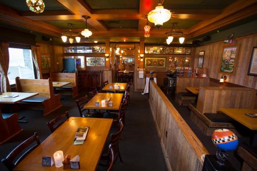 an empty restaurant with wooden tables and chairs at McMenamins Gearhart Hotel in Gearhart