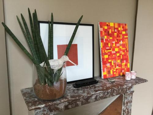 a table with a vase with a plant on it at Le HWell in Saint-Valery-sur-Somme