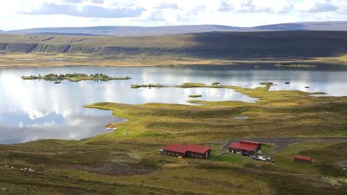 an island in the middle of a large body of water at Vestmannsvatn Guesthouse in Aðaldalur