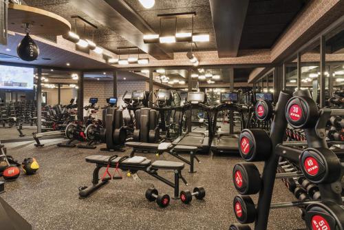 a gym with a lot of treadmills and weights at San Francisco Proper Hotel, a Member of Design Hotels in San Francisco