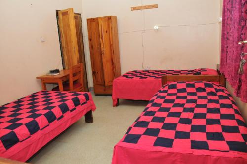 a room with two beds in a room at New Court View Hotel in Masindi