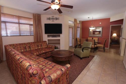 a living room filled with furniture and a tv at The Cliffs at Peace Canyon in Las Vegas