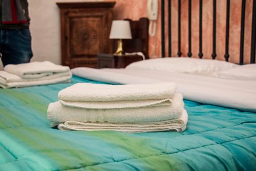 a pile of towels sitting on top of a bed at Apulia '800 in San Pietro Vernotico