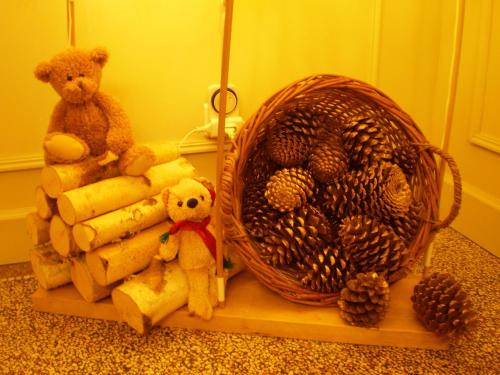 a bunch of stuffed animals and a basket on a shelf at Chambres d'Hôtes le Clos des Lesses in Fresse-sur-Moselle