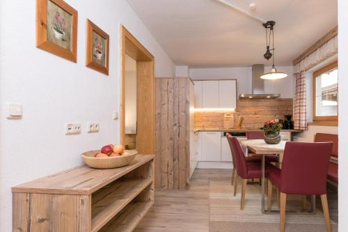 a kitchen and dining room with a table and chairs at Pension Margretenhof in Fulpmes