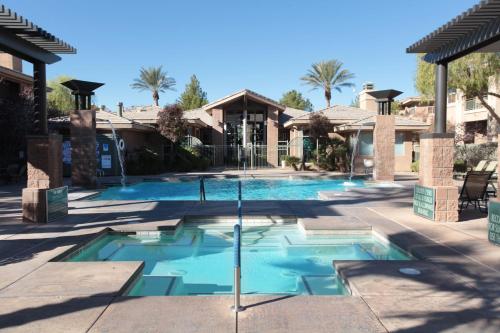 a swimming pool with a fountain in a yard at The Cliffs at Peace Canyon in Las Vegas