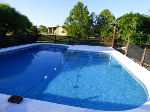 a large pool with blue water in a backyard at La Flute - Los Aromos in Santa Ana
