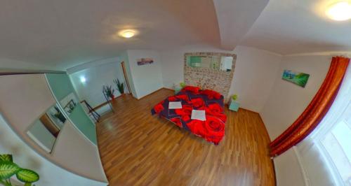 an overhead view of a bedroom with a red bed at Csikos Apartment in Cluj-Napoca