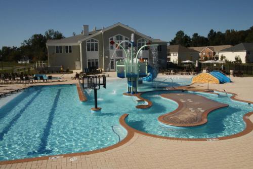 a pool with a water slide in a resort at The Colonies at Williamsburg in Williamsburg