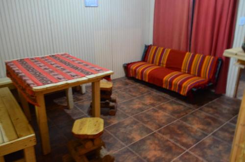 a living room with a couch and a table at Cabaña Laynaturi in San Pedro de Atacama