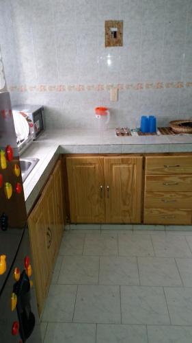 a kitchen with a sink and a counter top at Miss Leila in San Andrés