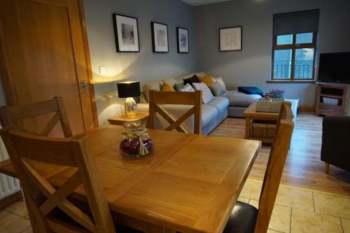 a living room with a wooden table and a couch at Dromore Court in Warrenpoint