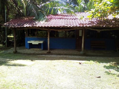 a small blue building with a red roof at Villas Maria Luisa in Uvita