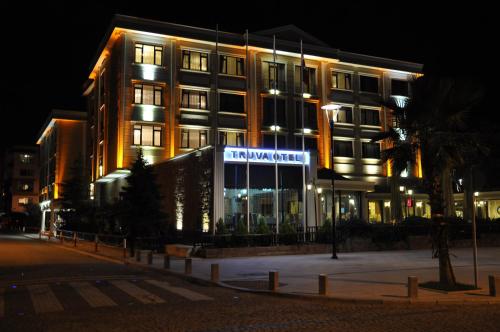 a building with a sign in front of it at night at Buyuk Truva Hotel in Canakkale