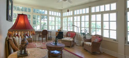 a large living room with a lot of windows at Alexander Mansion Bed & Breakfast in Winona