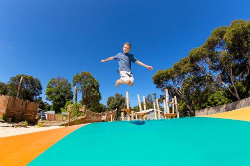 a man jumping over a trampoline at BIG4 Anglesea Holiday Park in Anglesea