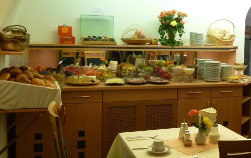 a kitchen with a bunch of food on a counter at Hotel Möve garni in Lindau